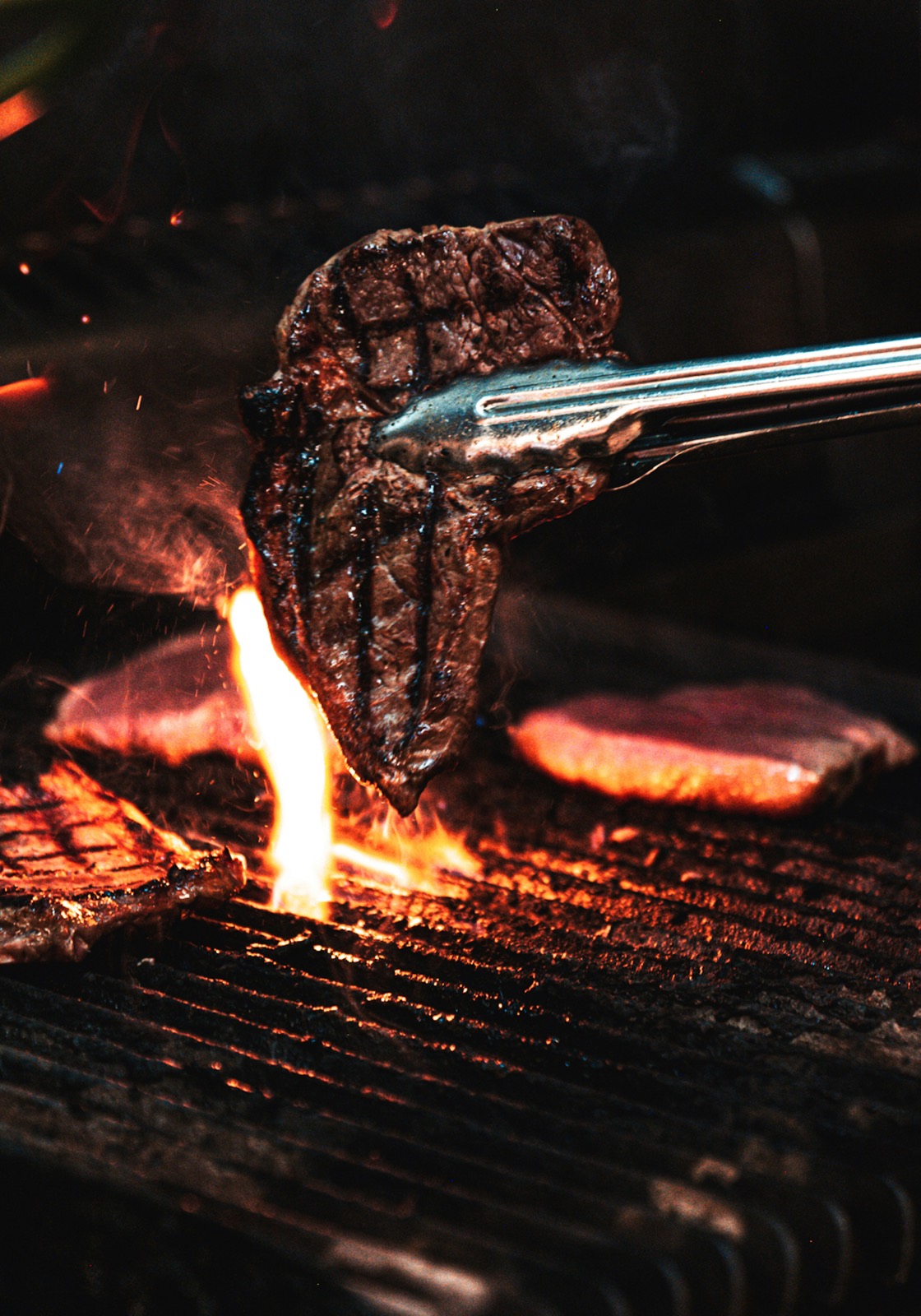 Meat over an open flame on the grill